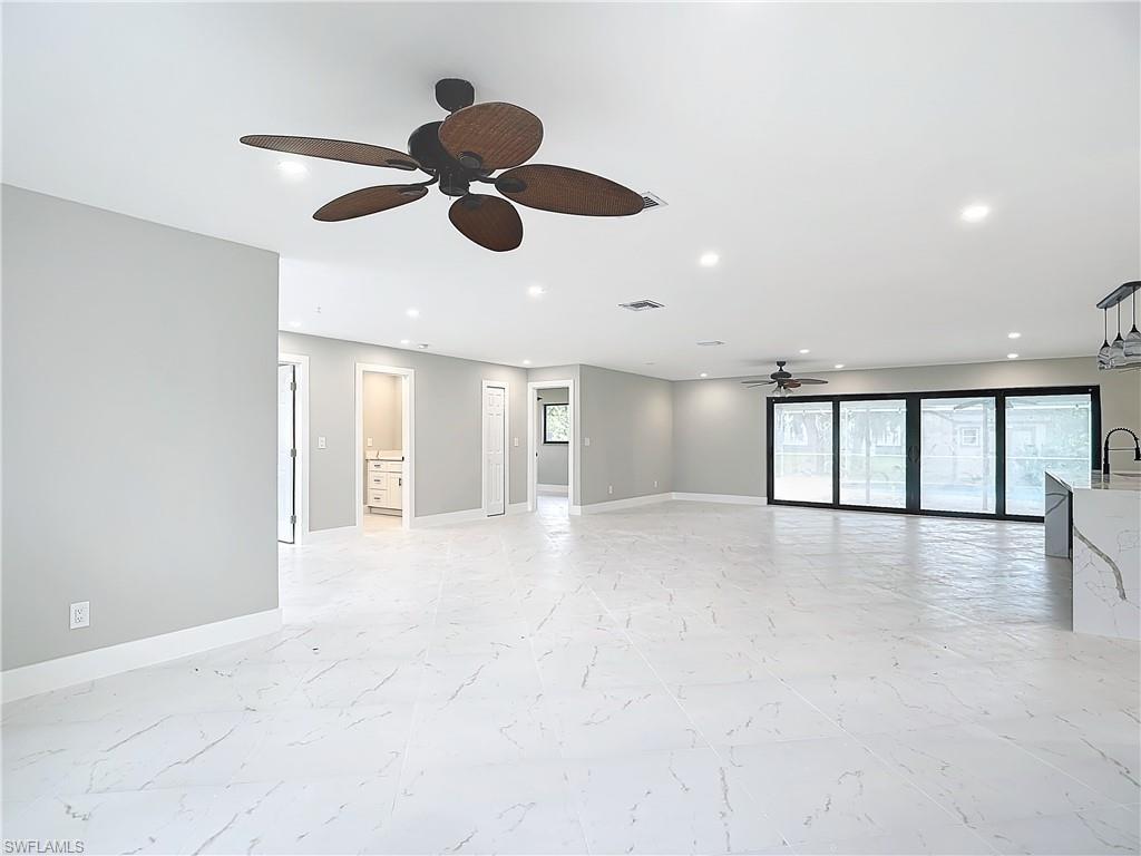 Image 3: Empty room with sink, ceiling fan, and light tile floors