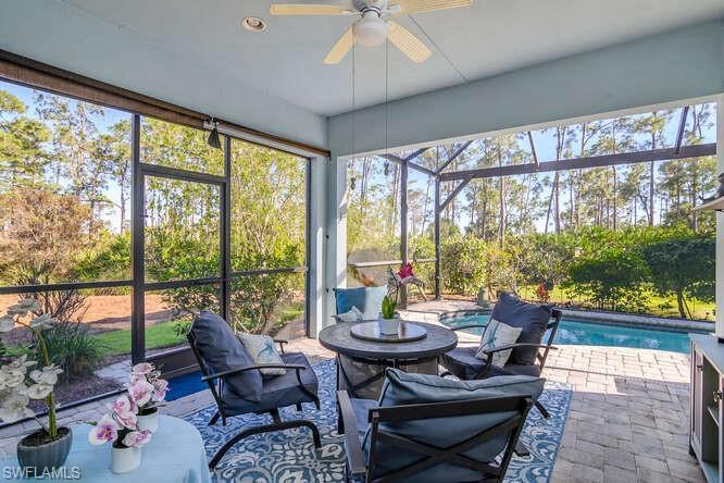 Image 4: Screened Lanai with ceiling fan, a swimming pool, a patio area, and plenty of natural light.