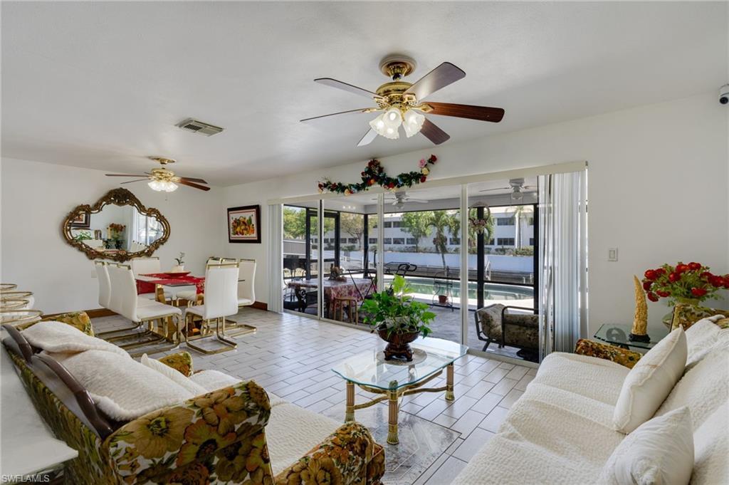 Image 2: Living and dining areas with tile flooring