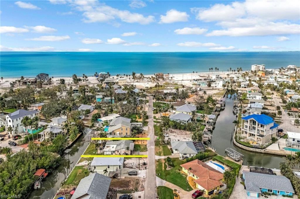 Image 1: Drone / aerial view featuring a water view and a residential view
