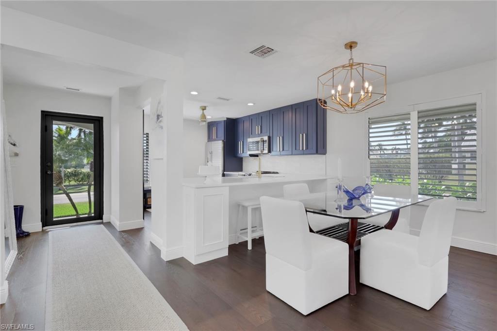 Image 4: Dining area featuring dark wood-type flooring, a chandelier, and recessed lighting