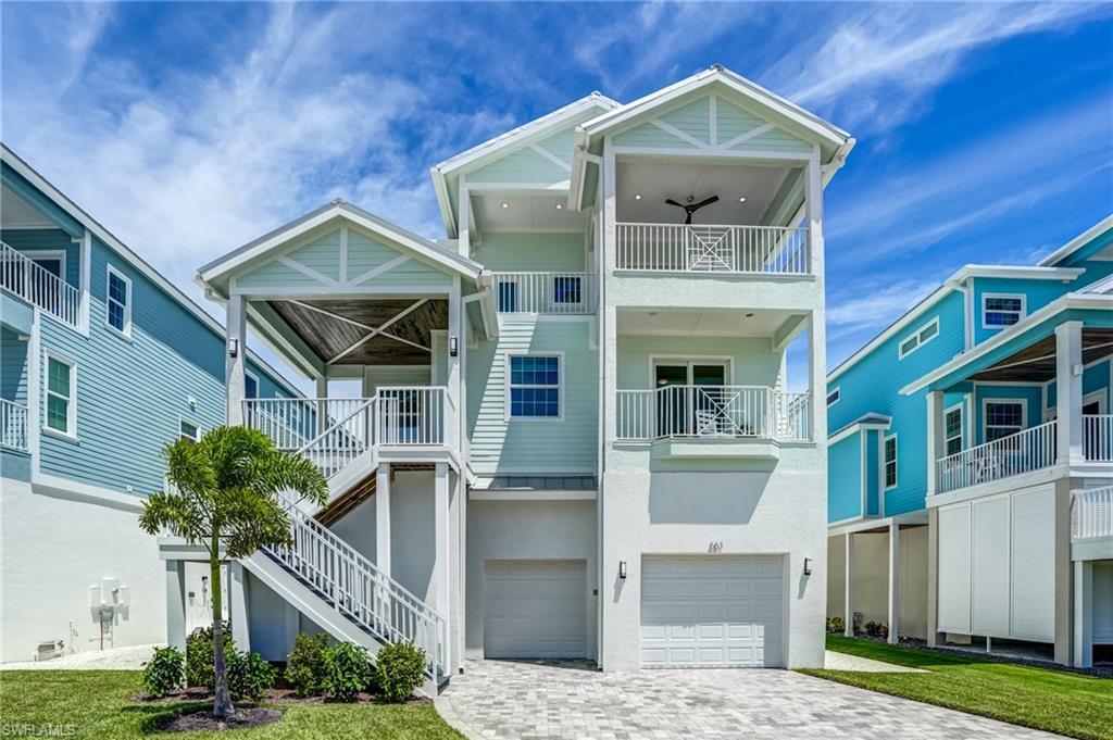 Image 1: Elevated Coastal home featuring Sunset Decks, decorative driveway, a garage, lots of room for Toys -Virtually Edited Image