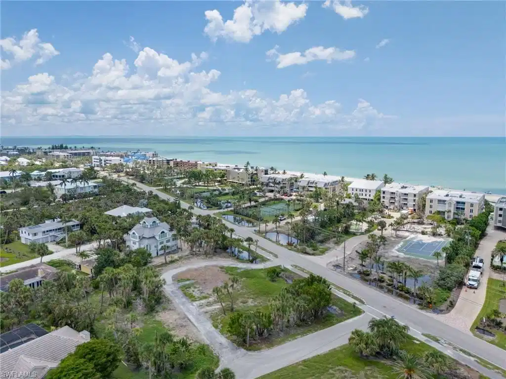Image 1: Aerial overview of property's location with a large body of water