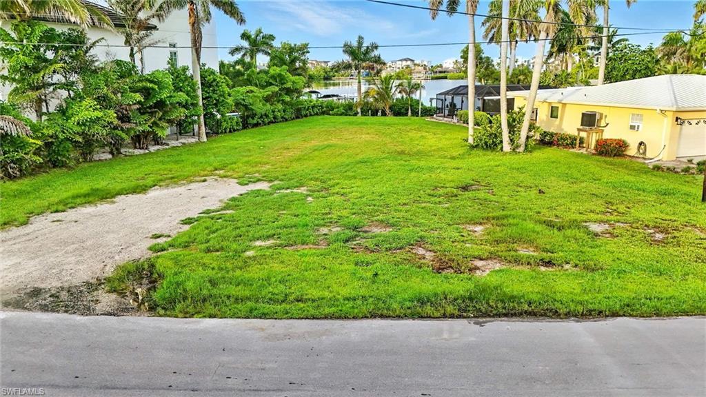 Image 2: View of grassy yard with a water view