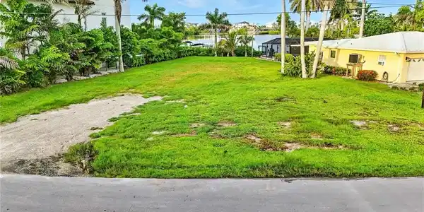 Image 2: View of grassy yard with a water view