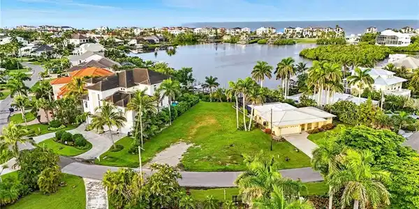 Image 3: Aerial perspective of suburban area with a nearby body of water