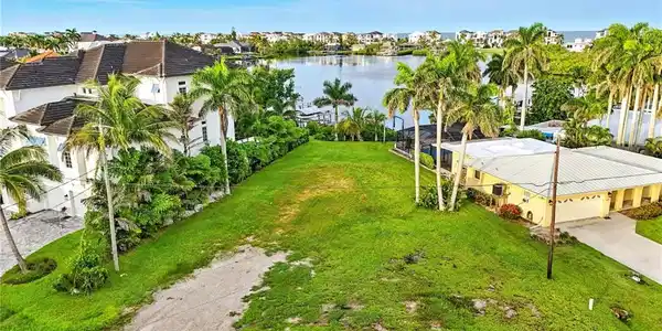Image 4: Aerial view of residential area with a large body of water