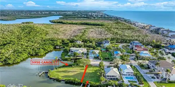 Image 4: Aerial perspective of suburban area featuring a large body of water