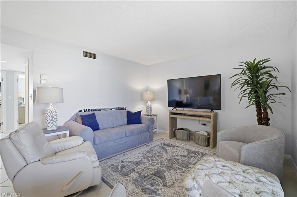 Image 3: Ligh colored tiled living room.