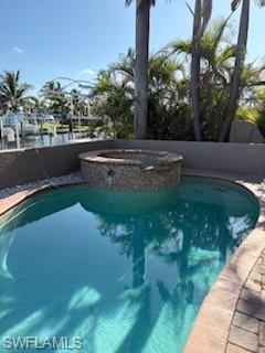 Image 2: View of swimming pool featuring a pool with connected hot tub