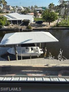 Image 3: Dock featuring a water view and boat lift