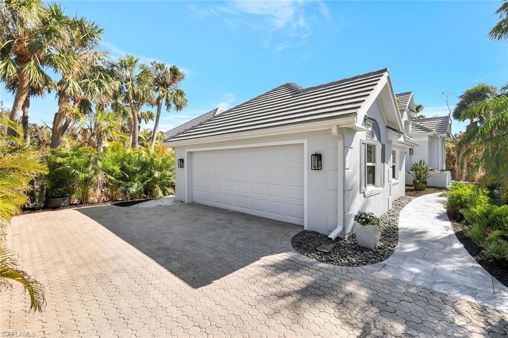 Image 4: View of property exterior featuring a garage