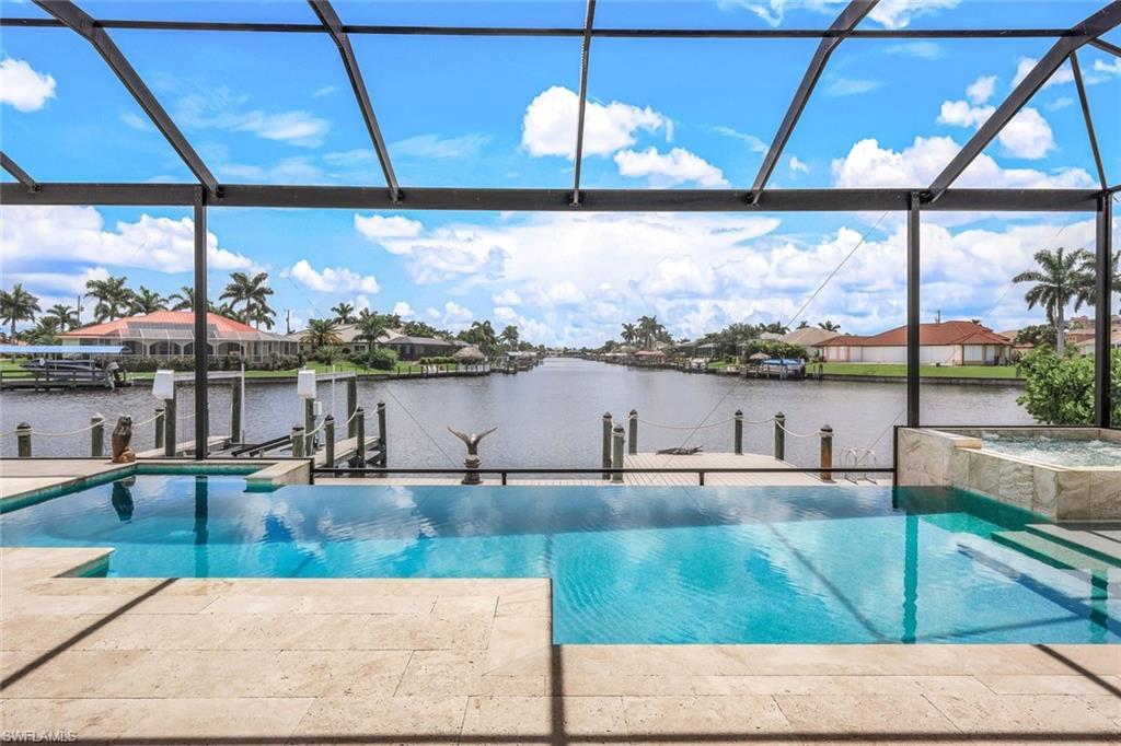 Image 1: View of pool featuring a water view, a boat dock, and a lanai