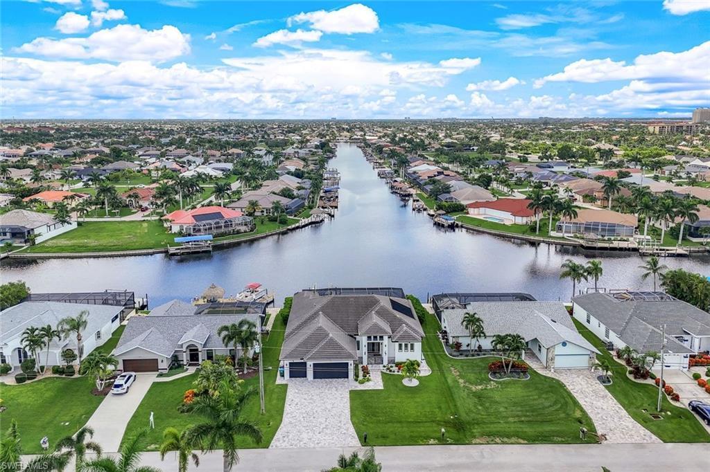 Image 4: Aerial perspective of suburban area featuring a large body of water