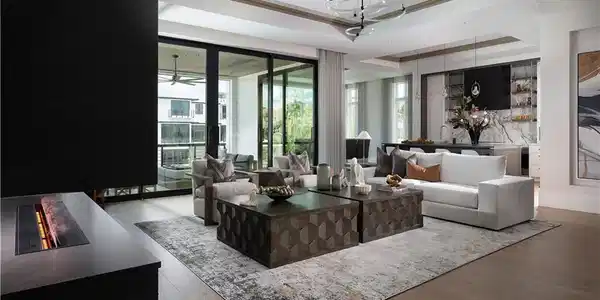 Image 3: Spacious open-concept living area featuring wood-finish flooring and extensive sliding glass doors