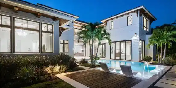 Image 3: Rear view of house with an outdoor pool