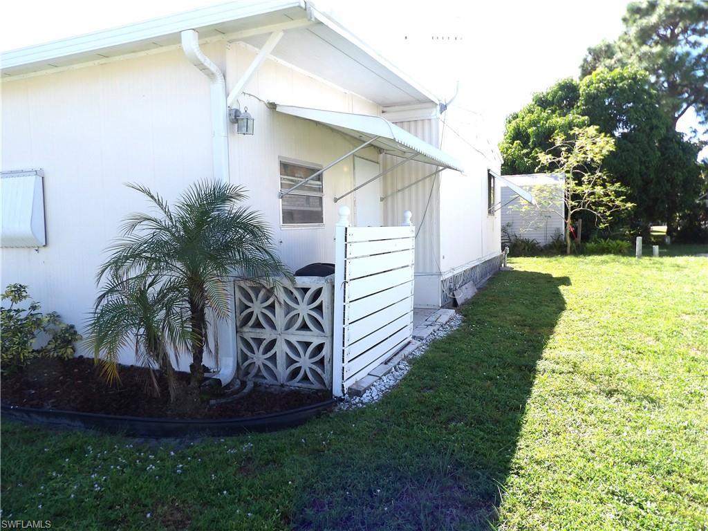 Image 3: View of property exterior featuring a lawn