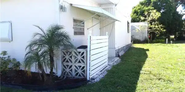 Image 3: View of property exterior featuring a lawn