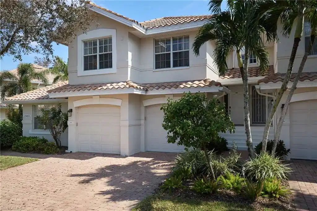 Image 1: Mediterranean / spanish-style house with a garage, a tiled roof, stucco siding, and decorative driveway