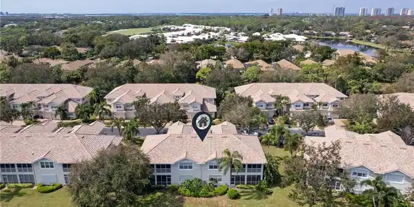 Image 4: Aerial view of residential area with a large body of water