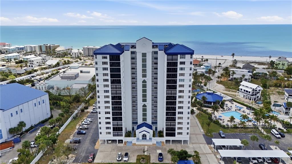 Image 1: Ocean Harbor Condominium and a nearby body of water - Virtually Edited Image