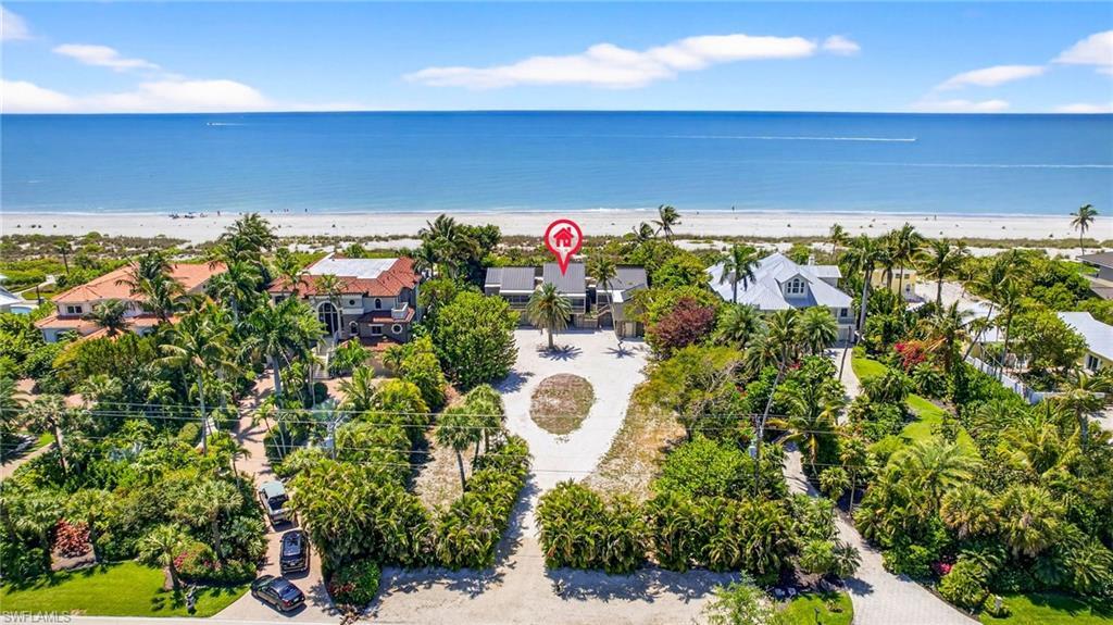 Image 1: Aerial view of residential area with expansive beach