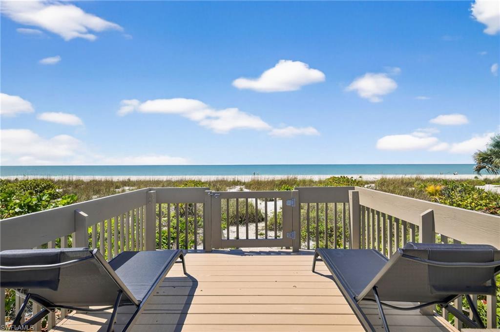 Image 3: Wooden deck with view of water and beach