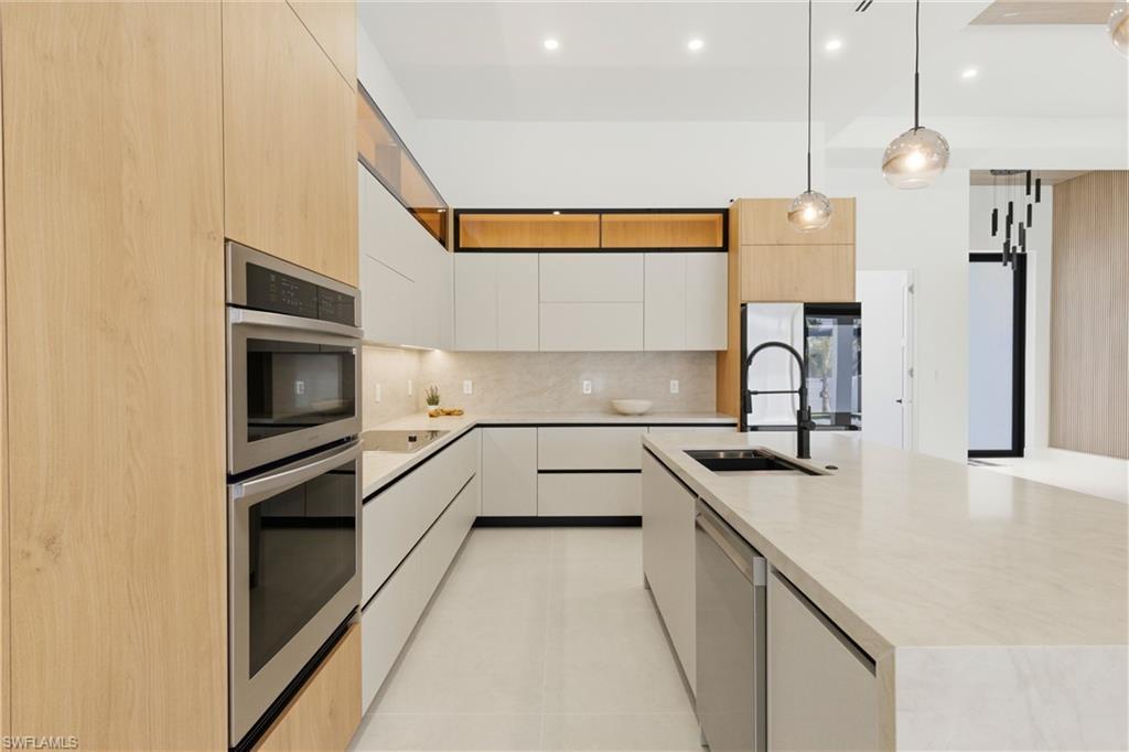 Image 1: Top-of-the-line CABINETRY, under- & top-cabinet lighting, TAJ MAHAL-inspired quartz countertops, full backsplash, POT FILLER