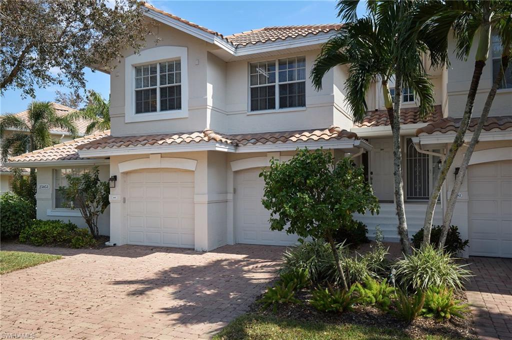Image 1: Mediterranean / spanish-style house with a garage, a tiled roof, stucco siding, and decorative driveway