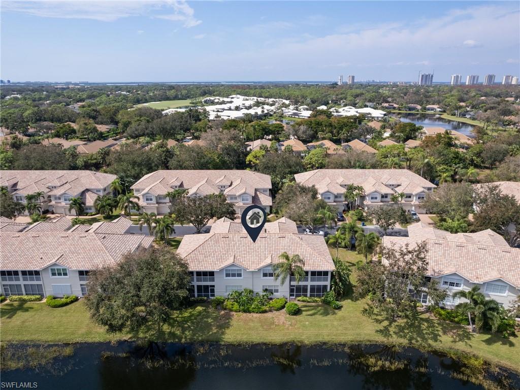 Image 4: Aerial view of residential area with a large body of water