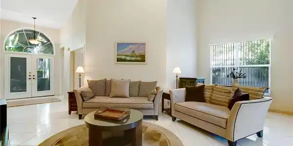 Image 2: Living area featuring high vaulted ceiling, tile floors, lots of natural light