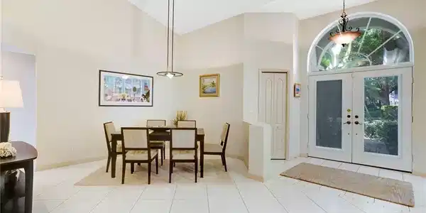 Image 4: Dining space featuring an abundance of natural light, tile floors, and vaulted ceiling