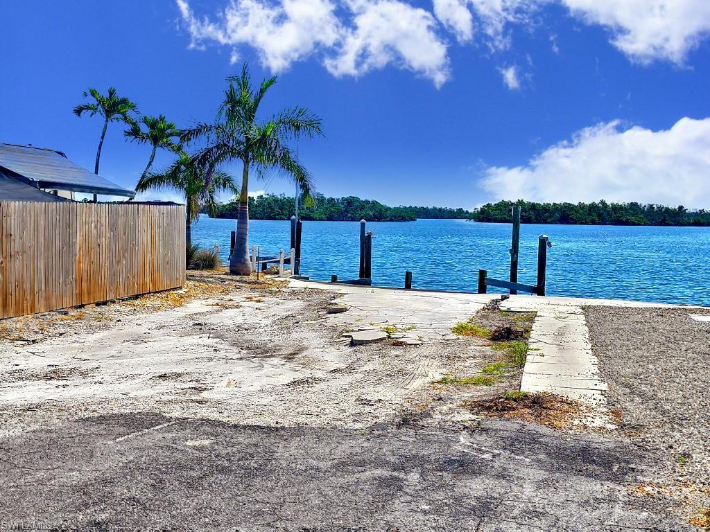 Image 4: View of yard featuring a water view and a boat dock