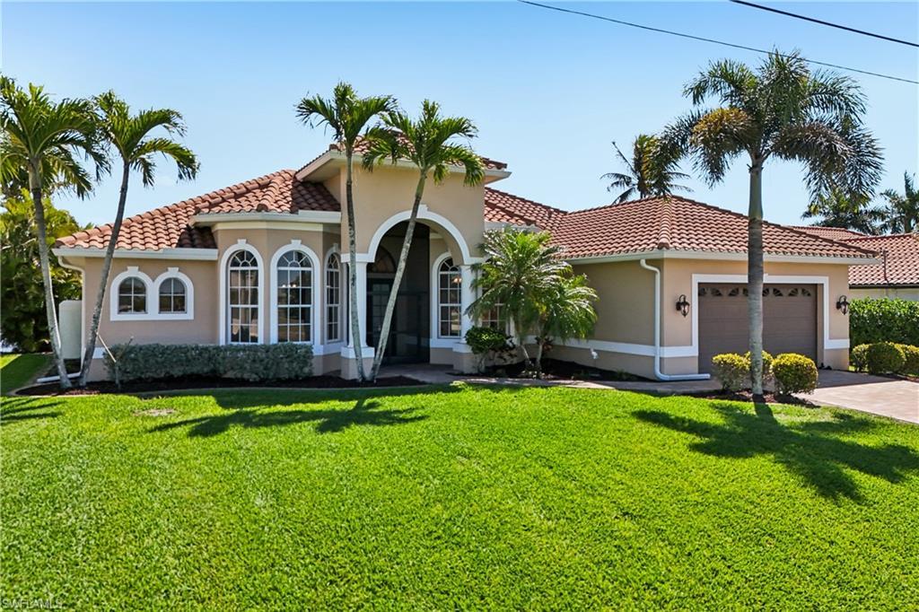 Image 2: Mediterranean / spanish-style house featuring stucco siding, an attached garage, a front lawn, and a tile roof