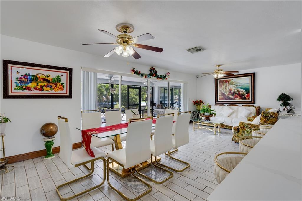 Image 4: Open-concept living area with white tile flooring throughout