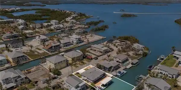 Image 2: Aerial perspective of suburban area with a nearby body of water