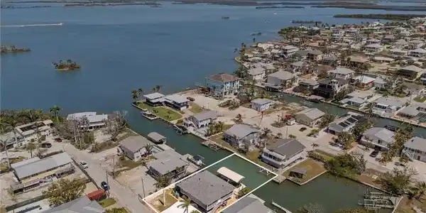 Image 3: Aerial view of residential area with a large body of water
