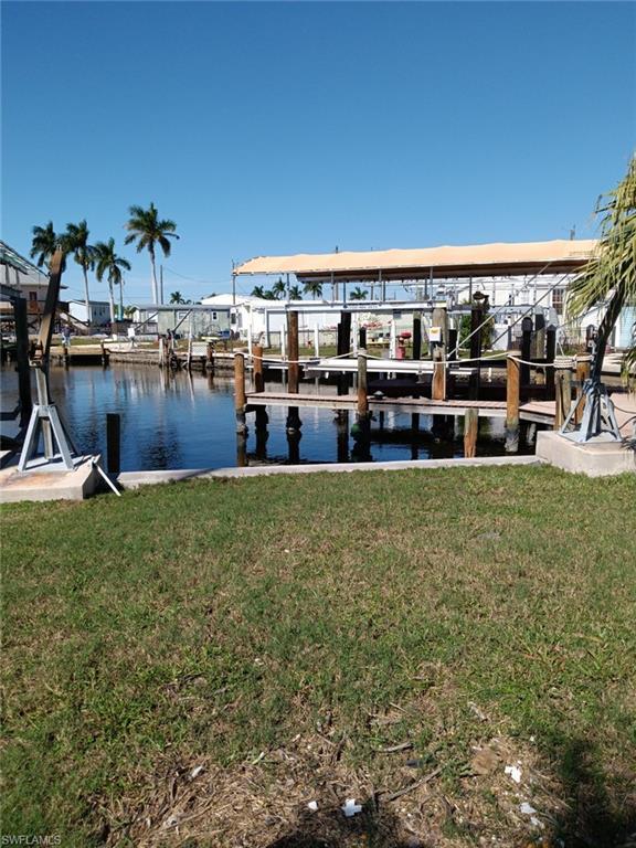 Image 1: View of dock with a water view and a yard
