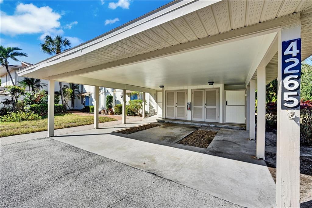 Image 2: View of car parking featuring mail area and an attached carport