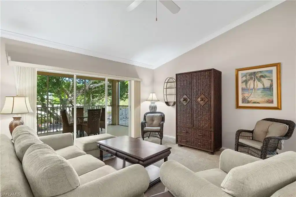 Image 1: Living room featuring crown molding, vaulted ceiling, ceiling fan, and light colored carpet