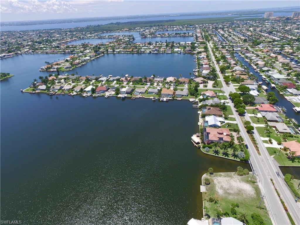 Image 3: Aerial overview of property's location with a nearby body of water and nearby suburban area