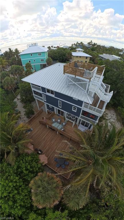 Image 3: Elevated coastal residence featuring a metal roof and multiple levels of outdoor decking