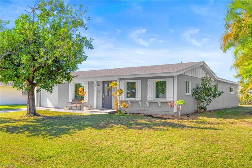 Image 4: Single story home with a front yard, a shingled roof, and a porch