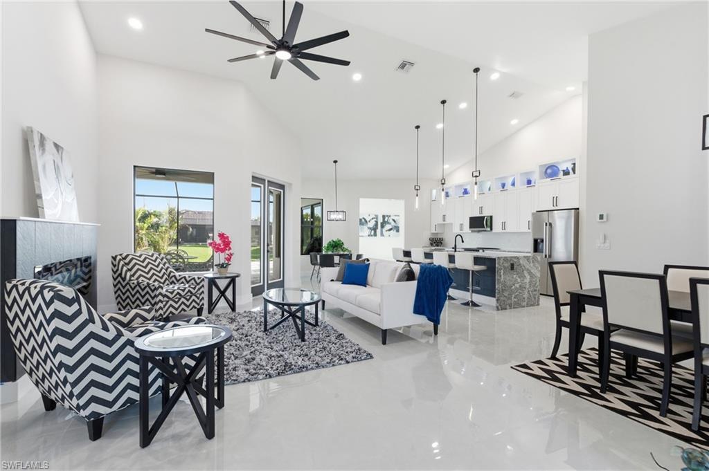 Image 3: Living room featuring a ceiling fan, recessed lighting, and vaulted ceiling