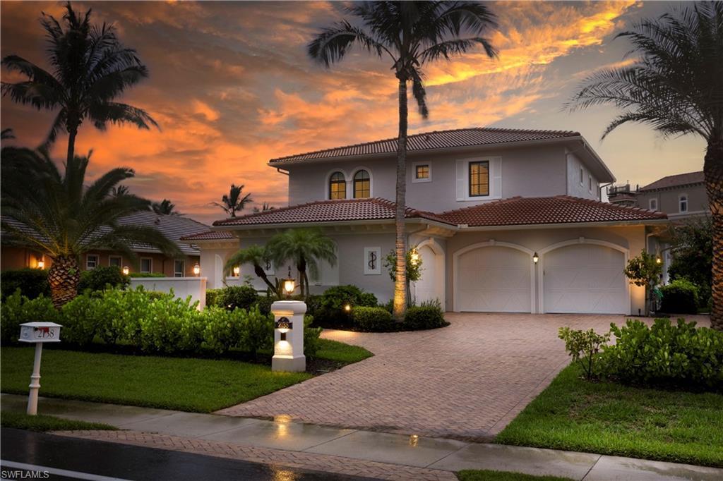 Image 1: Custom Sailboat Gulf--access home with southern exposure,, featuring pavered driveway, LED outdoor lighting, new interior and exterior paint (2025) stucco siding, a new tile roof (2023), and a front court yard.