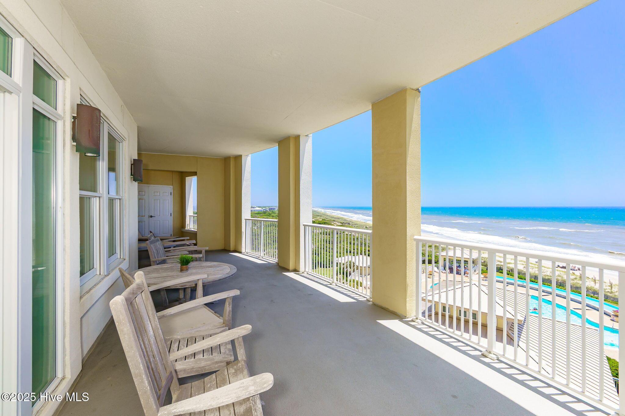 Image 2: Covered patio overlooking beach and pool