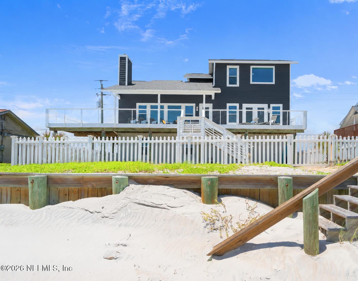 Image 1: Yard View with Sea Wall