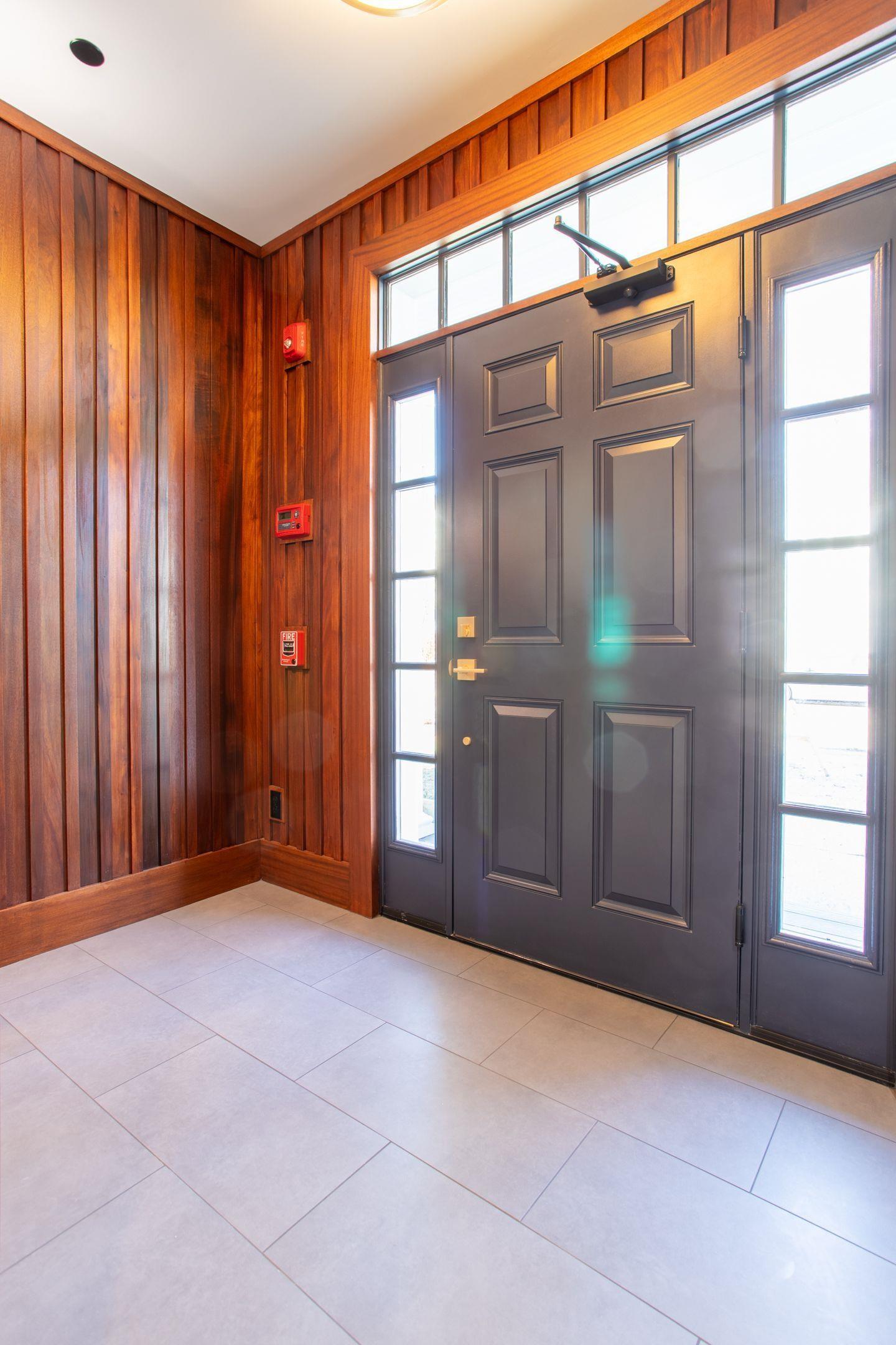 Image 4: Front foyer with solid mahogany walls