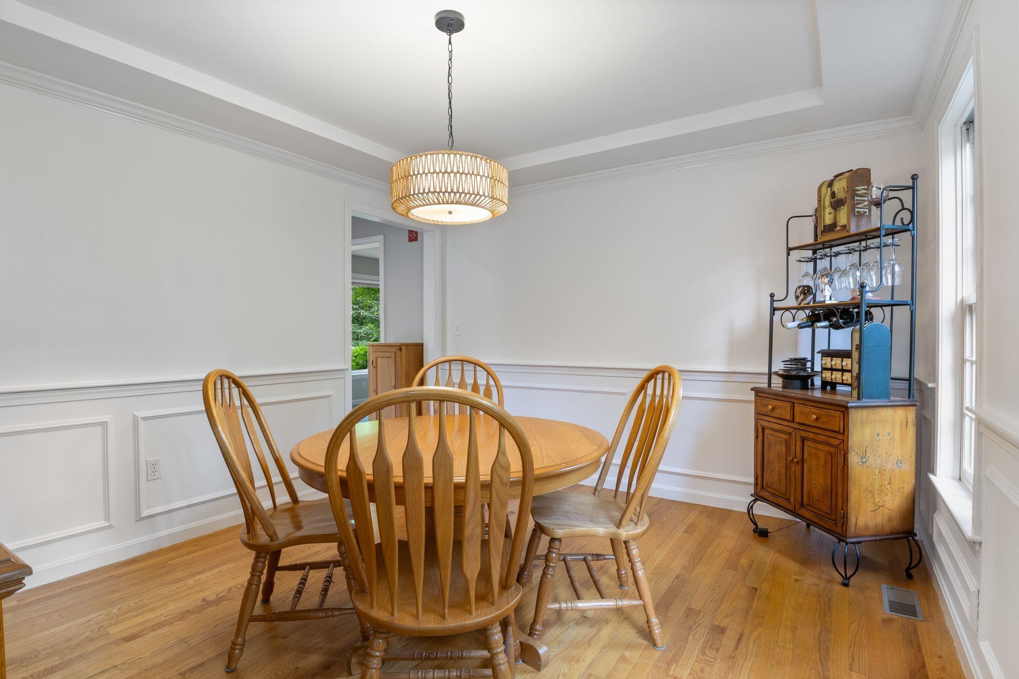 Image 3: Dining room with tray ceiling and chair railing