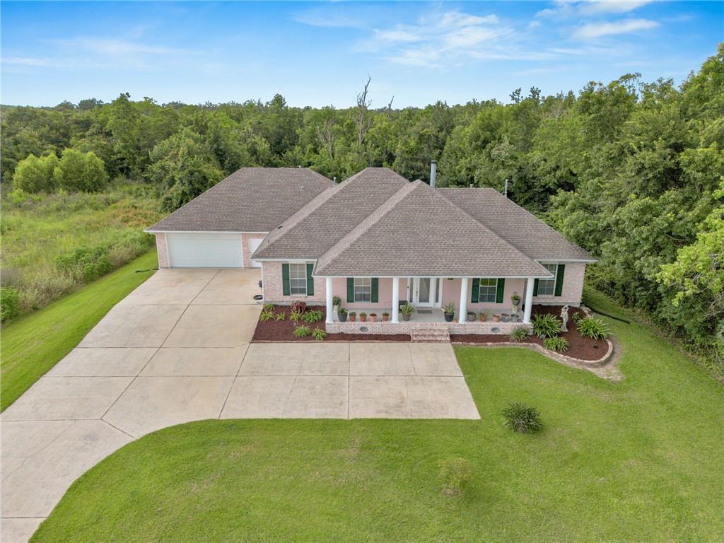 Image 1: Front of house with enough parking for 12-14 cars